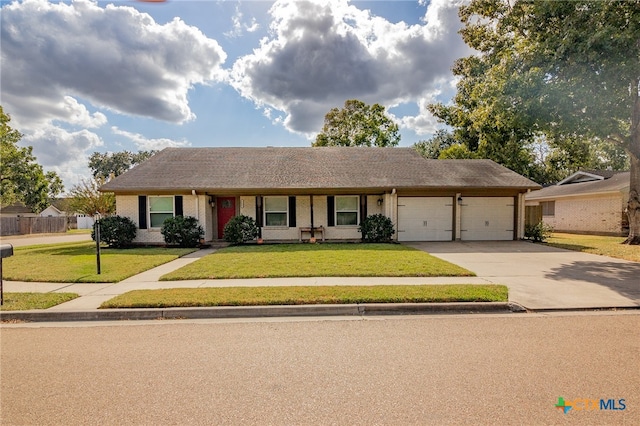 single story home with a garage and a front lawn