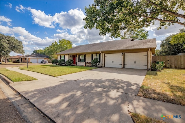 ranch-style house with a garage and a front lawn