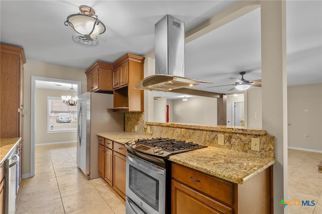 kitchen featuring extractor fan, light stone counters, appliances with stainless steel finishes, ceiling fan with notable chandelier, and backsplash