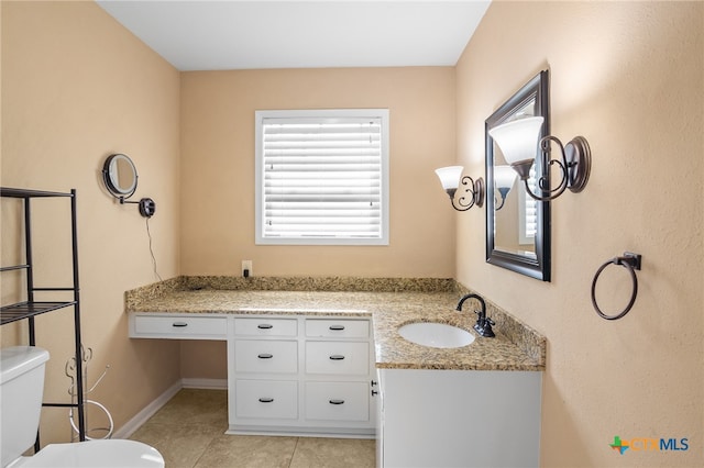 bathroom featuring tile patterned flooring, vanity, and toilet