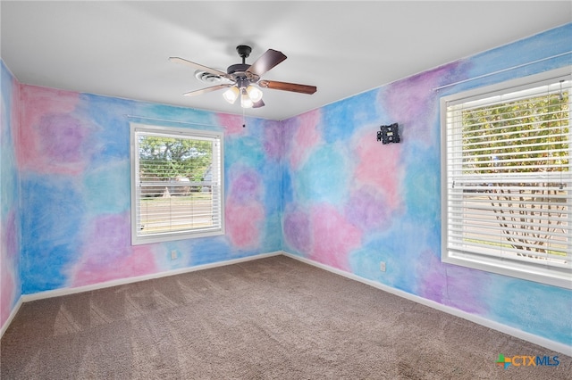 spare room with carpet and ceiling fan