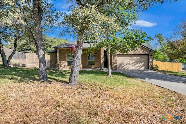 ranch-style home featuring a garage and a front yard