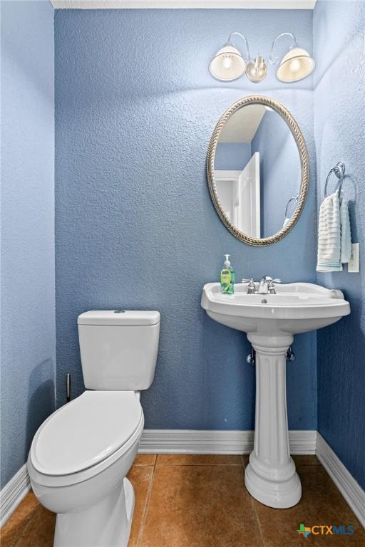 2105 Yak Trl, Harker Heights, TX 76548 - half bathroom featuring tile patterned floors, toilet, and baseboards