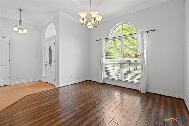 2105 Yak Trl, Harker Heights, TX 76548 - empty room with a chandelier, wood finished floors, crown molding, and baseboards