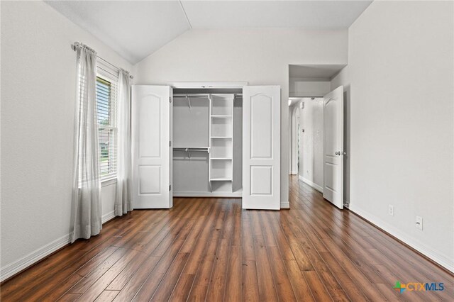 2105 Yak Trl, Harker Heights, TX 76548 - unfurnished bedroom featuring wood finished floors, lofted ceiling, baseboards, a walk in closet, and a closet