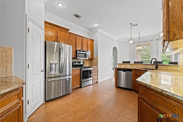 2105 Yak Trl, Harker Heights, TX 76548 - kitchen with stainless steel appliances, a sink, arched walkways, tasteful backsplash, and brown cabinetry