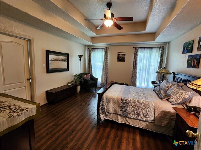 2105 Yak Trl, Harker Heights, TX 76548 - bedroom with wood finished floors, a tray ceiling, a ceiling fan, and baseboards