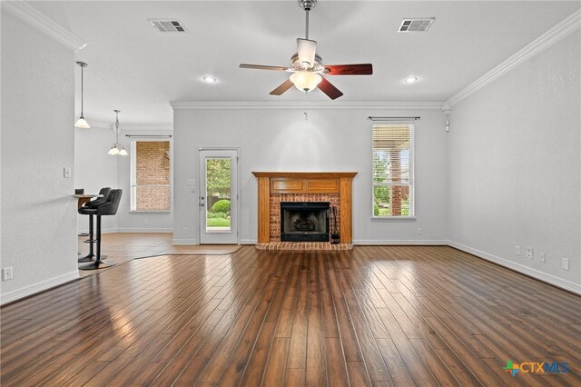 2105 Yak Trl, Harker Heights, TX 76548 - unfurnished living room with ceiling fan, wood-type flooring, crown molding, a fireplace, and baseboards