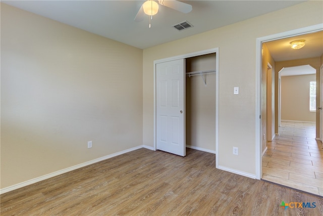 unfurnished bedroom featuring a closet, ceiling fan, and light hardwood / wood-style flooring