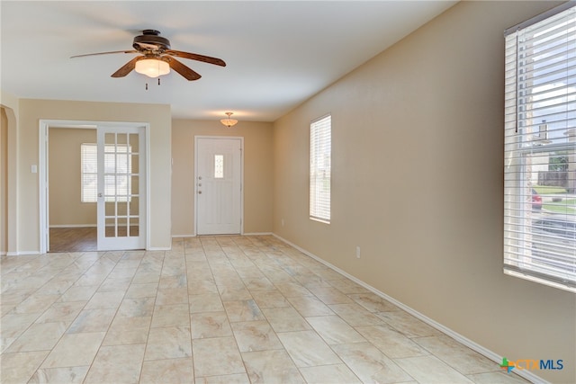 tiled foyer with ceiling fan