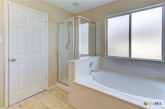 bathroom with tile patterned floors and independent shower and bath