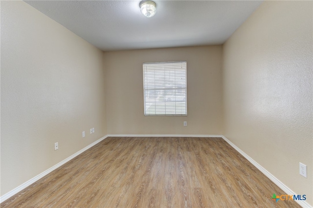 spare room with light hardwood / wood-style flooring