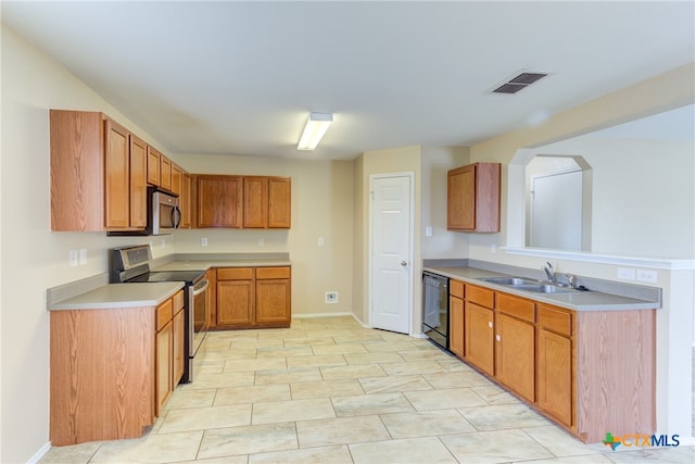 kitchen featuring stainless steel appliances, light tile patterned floors, and sink