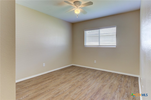 spare room featuring light hardwood / wood-style floors and ceiling fan