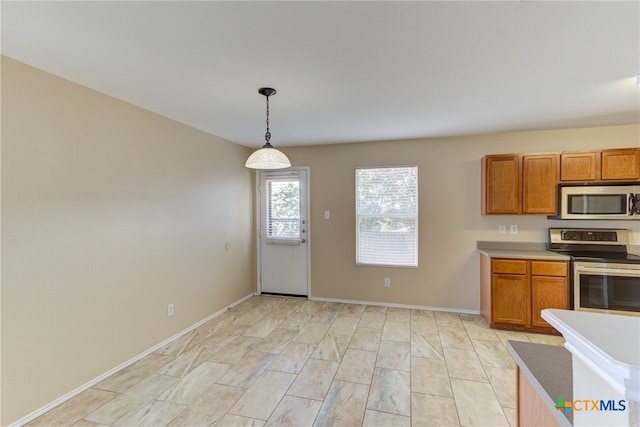 kitchen with pendant lighting and appliances with stainless steel finishes