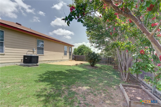 view of yard with central AC unit and a patio