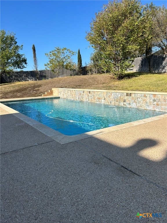 view of pool featuring a yard and pool water feature