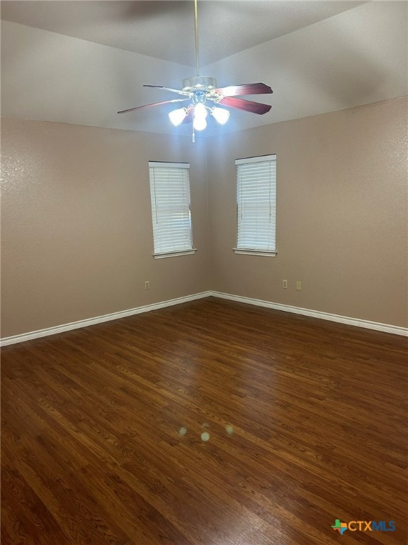 spare room with dark wood-type flooring, ceiling fan, and lofted ceiling