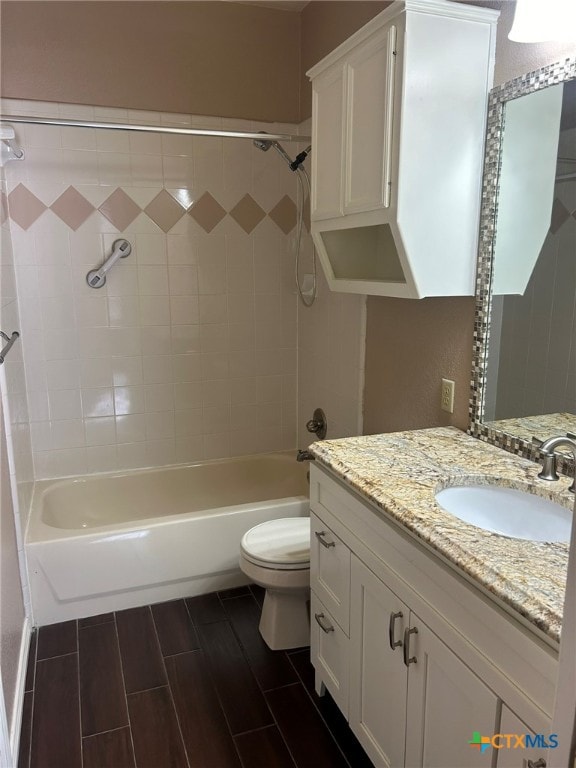 full bathroom featuring vanity, toilet, and tiled shower / bath