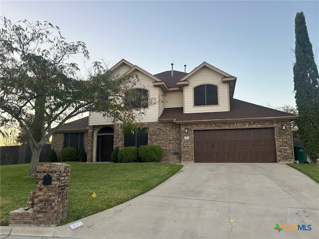 view of front of home with a front lawn and a garage