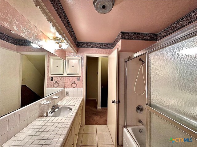 203 Hampshire St, Victoria, TX 77904 - full bathroom featuring tile patterned flooring, combined bath / shower with glass door, vanity, and backsplash