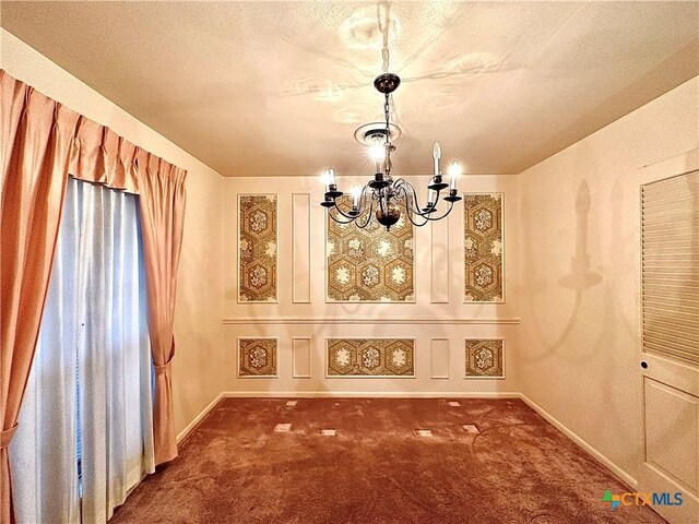 203 Hampshire St, Victoria, TX 77904 - unfurnished dining area featuring a chandelier, carpet floors, and baseboards