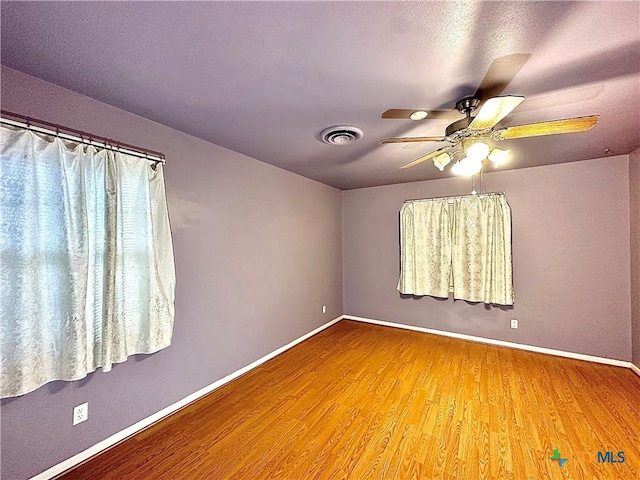 203 Hampshire St, Victoria, TX 77904 - spare room with wood finished floors, baseboards, and a ceiling fan
