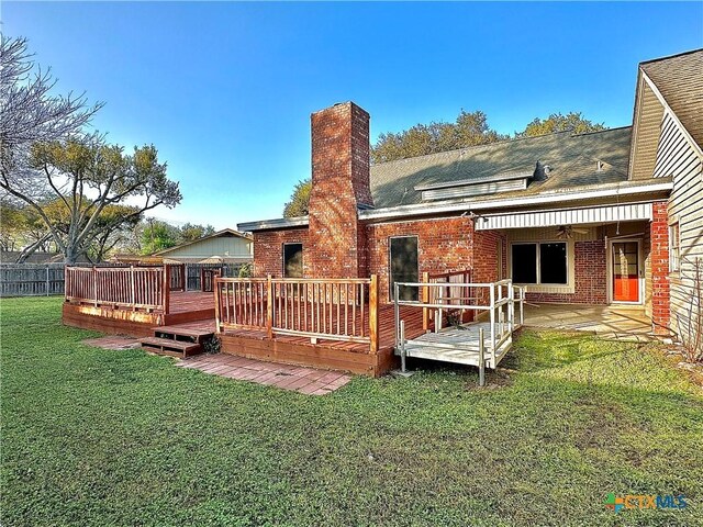 203 Hampshire St, Victoria, TX 77904 - rear view of house featuring brick siding, a chimney, and a wooden deck