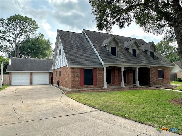 203 Hampshire St, Victoria, TX 77904 - cape cod home featuring brick siding, a porch, a front lawn, driveway, and roof with shingles