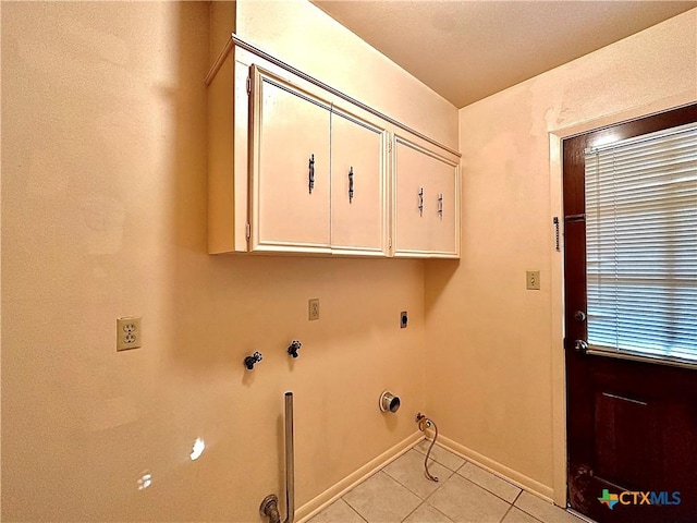 203 Hampshire St, Victoria, TX 77904 - laundry area with cabinet space, gas dryer hookup, light tile patterned flooring, baseboards, and electric dryer hookup