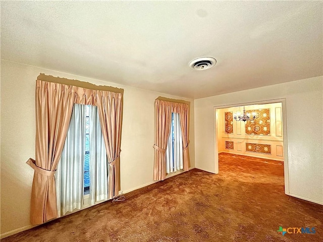 203 Hampshire St, Victoria, TX 77904 - spare room with carpet flooring, a chandelier, and baseboards