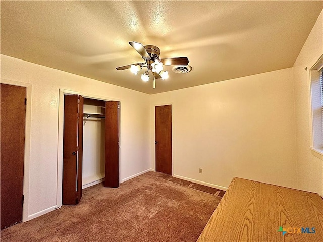 203 Hampshire St, Victoria, TX 77904 - unfurnished bedroom with carpet flooring, baseboards, ceiling fan, a textured ceiling, and a closet
