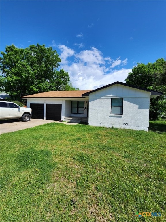 single story home with a front lawn and a garage