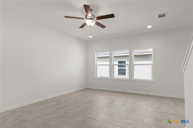 empty room with light tile patterned floors and ceiling fan