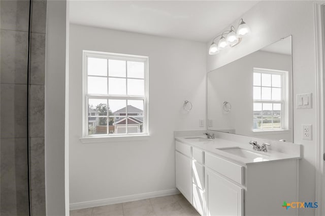 bathroom featuring tile patterned floors, vanity, and a healthy amount of sunlight