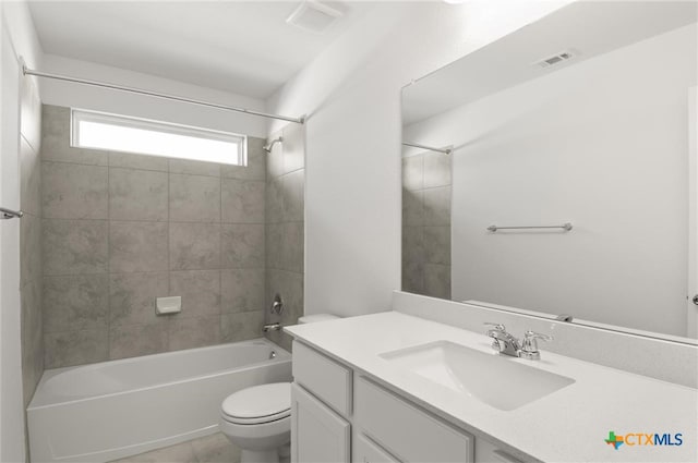 full bathroom featuring vanity, tile patterned floors, tiled shower / bath combo, and toilet