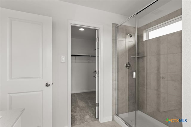 bathroom with tile patterned flooring and a shower with shower door