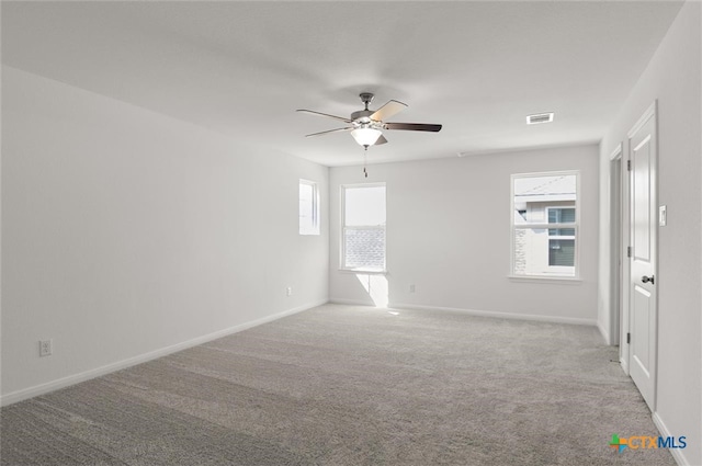 spare room with a healthy amount of sunlight and light colored carpet