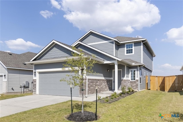 craftsman house featuring a front yard and a garage