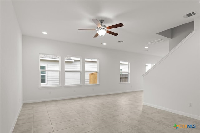 empty room featuring light tile patterned floors and ceiling fan