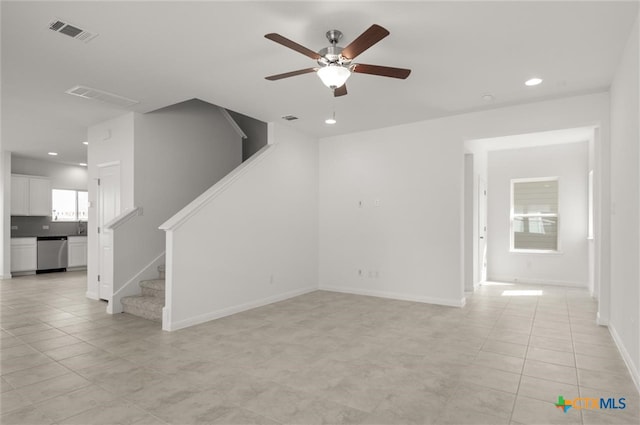 unfurnished living room with light tile patterned floors and ceiling fan