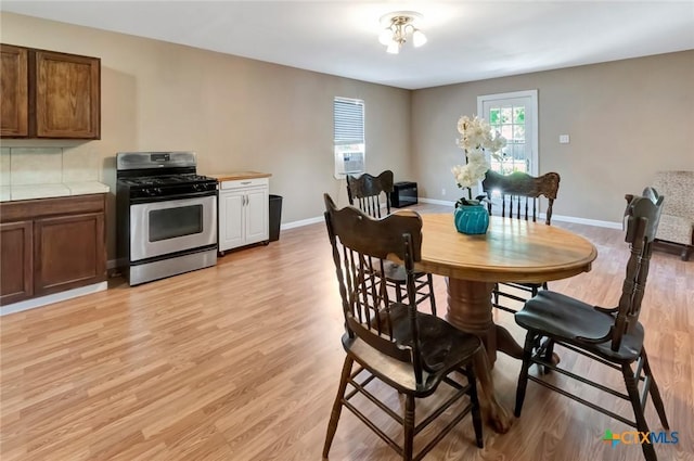 304 W Putnam, Ganado, TX 77962 - dining room with light wood-style flooring and baseboards
