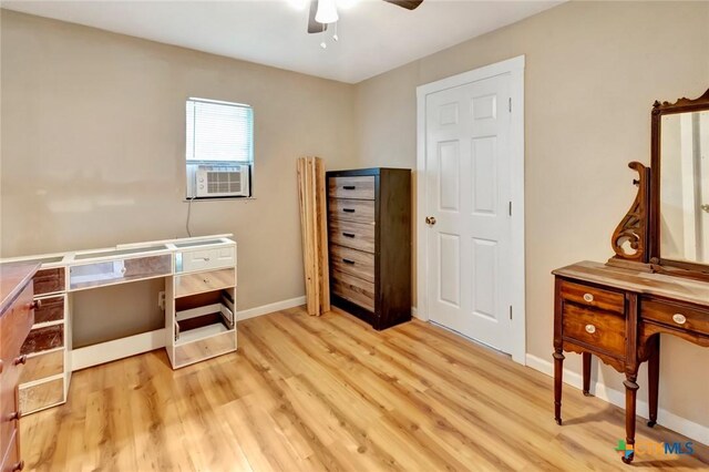 304 W Putnam, Ganado, TX 77962 - home office featuring ceiling fan, wood finished floors, baseboards, and cooling unit