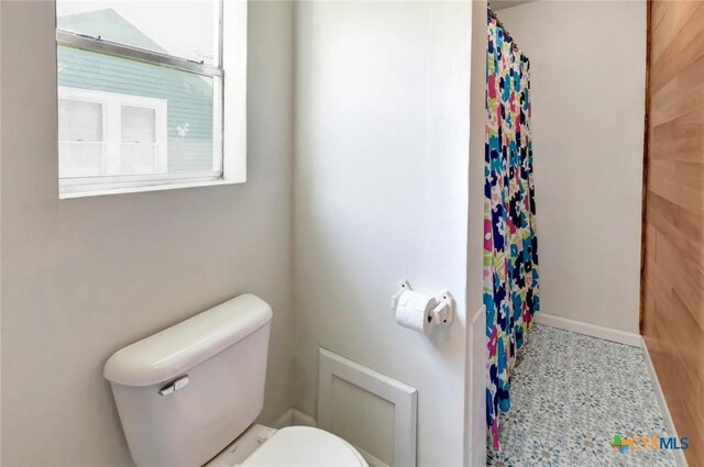 304 W Putnam, Ganado, TX 77962 - bathroom featuring toilet, healthy amount of natural light, and curtained shower