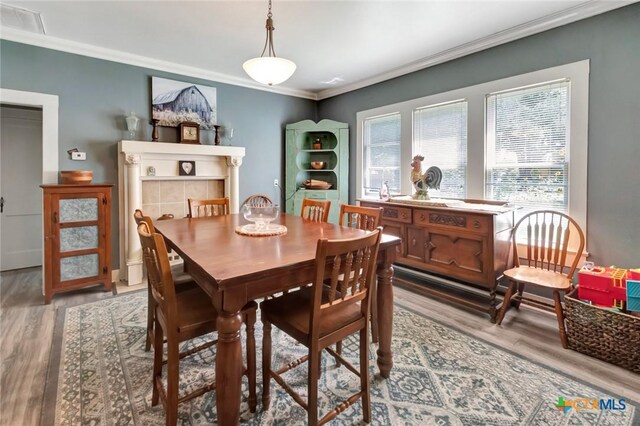 304 W Putnam, Ganado, TX 77962 - dining area with wood finished floors and crown molding