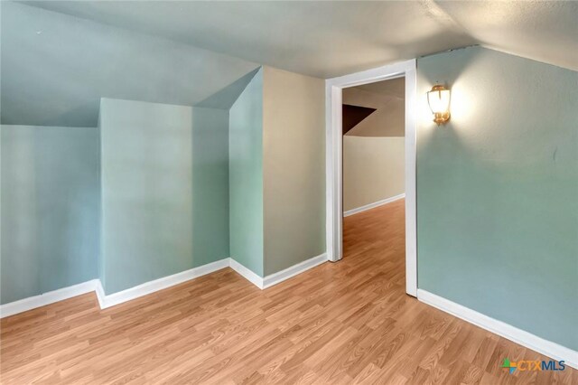 304 W Putnam, Ganado, TX 77962 - bonus room featuring vaulted ceiling, light wood-style floors, and baseboards