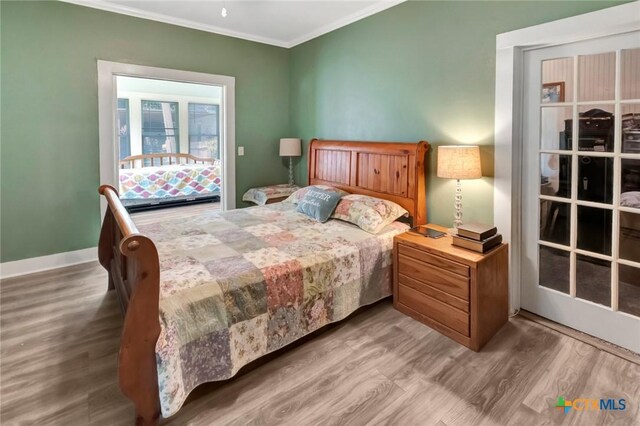 304 W Putnam, Ganado, TX 77962 - bedroom with wood finished floors and ornamental molding