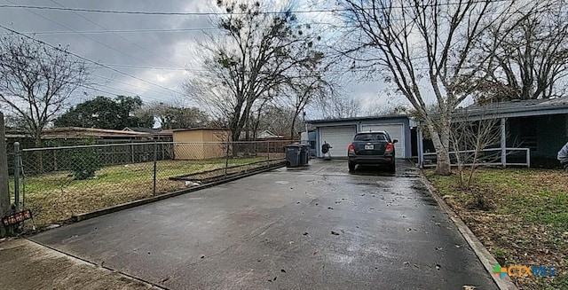 view of patio / terrace with an outbuilding and a garage