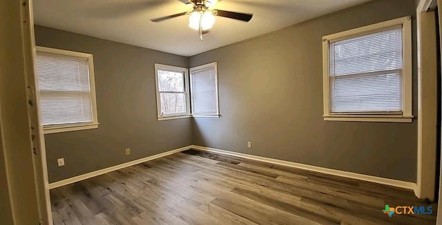 spare room featuring hardwood / wood-style flooring and ceiling fan