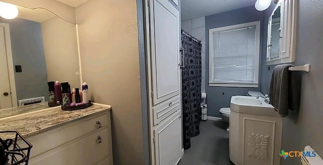 bathroom featuring vanity and toilet